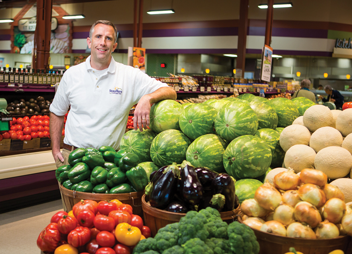 man with produce display