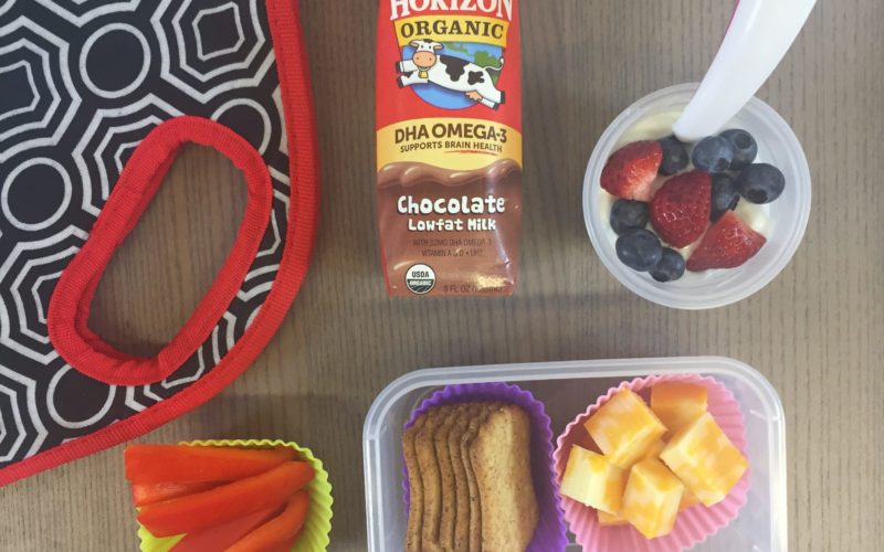 packed school lunch with cheese & crackers, yogurt with fruit, and peppers