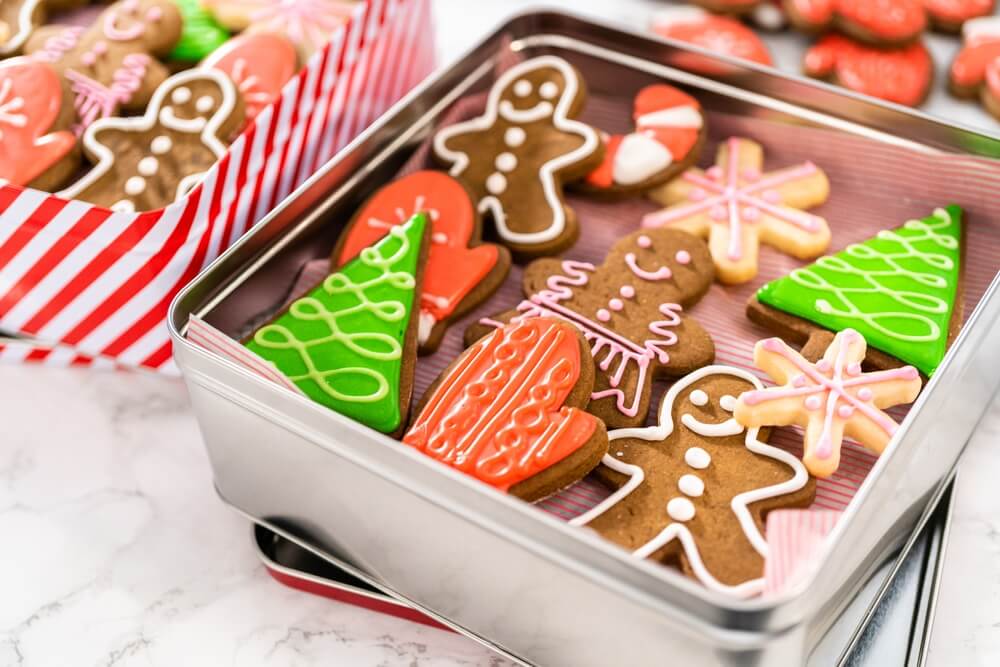 a tin of cookies decorated with frosting