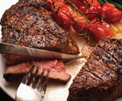 sirloin steak with fork and tomatoes