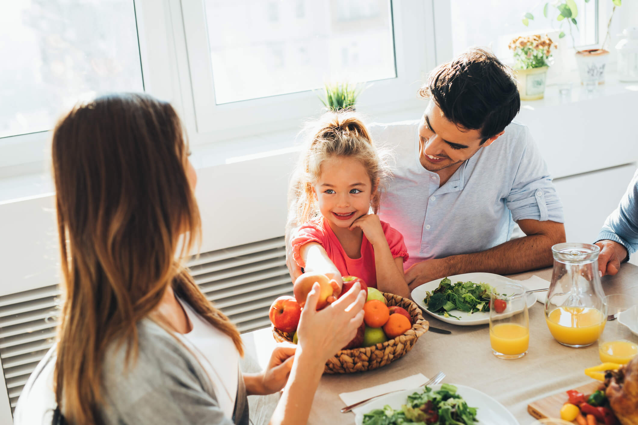 A family eats organic food with their child.