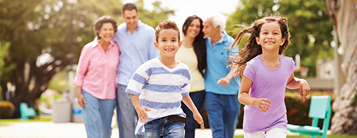 family with children running ahead