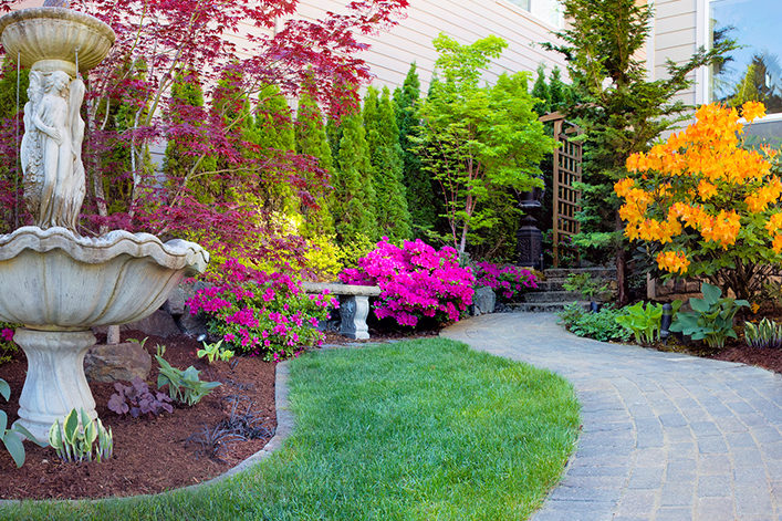 landscape with fountain, walkway, flowers