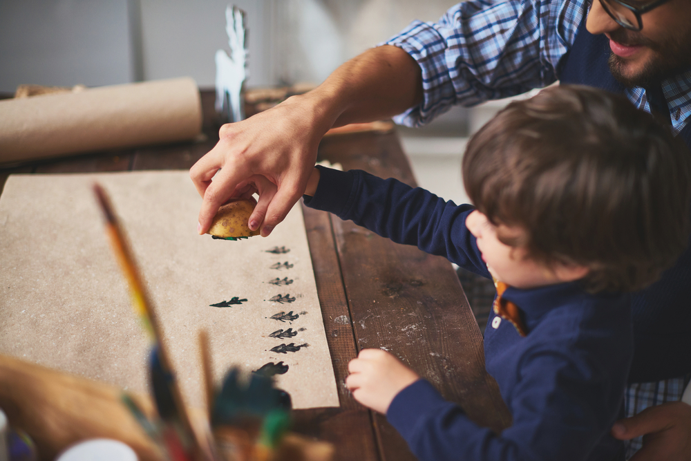 A father and son do a Christmas craft together