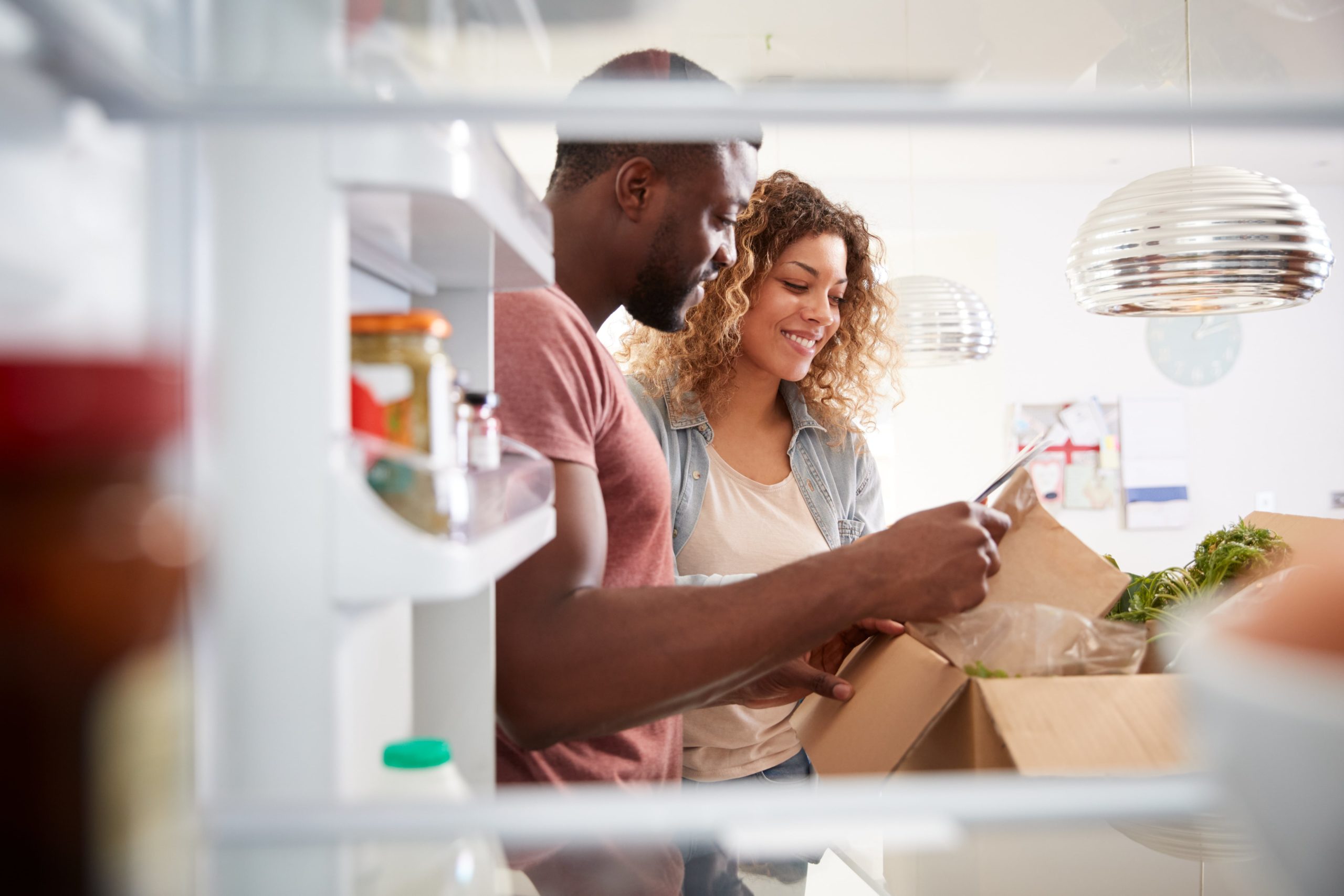 Couple unpacking their groceries.