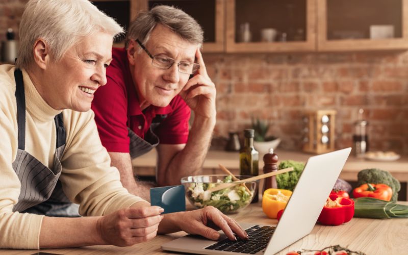 Couple creating a grocery list online.