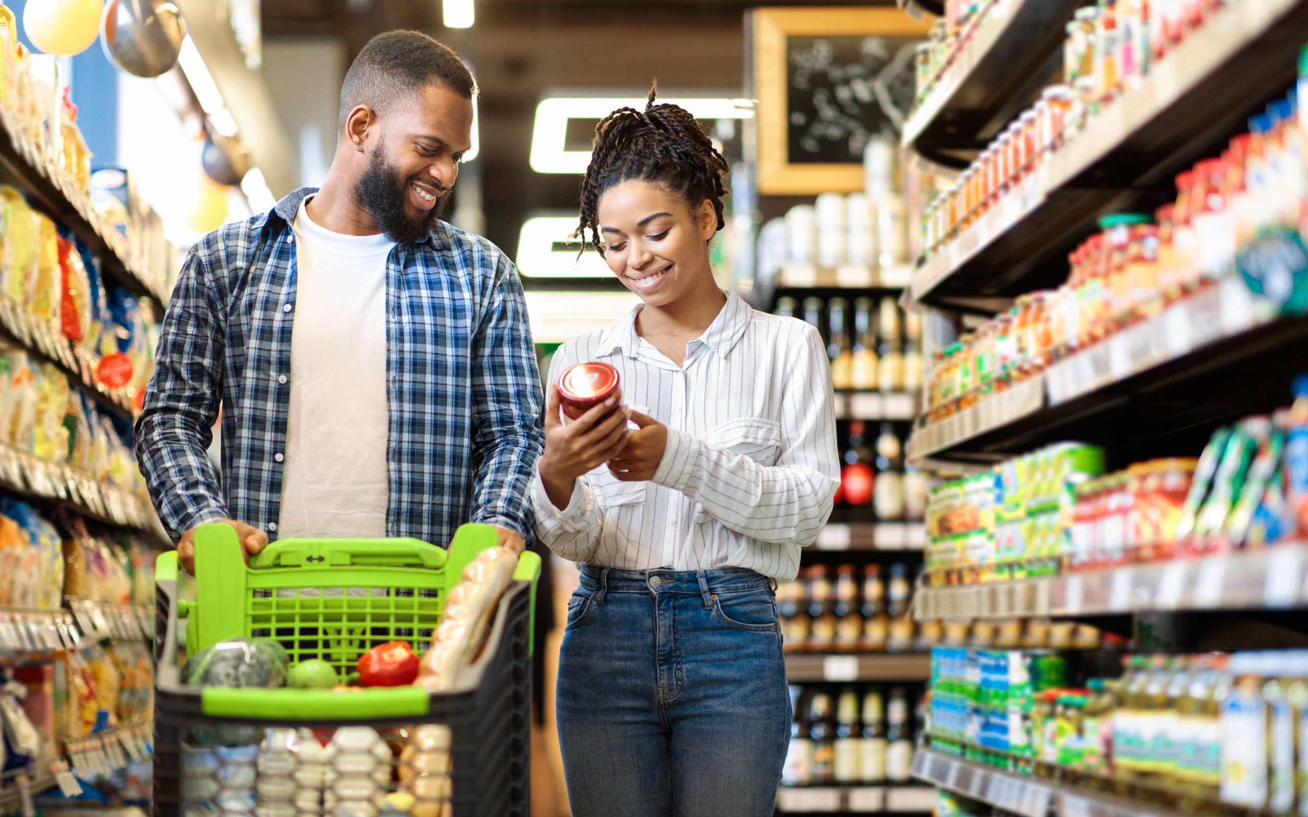 Couple looking at sales in grocery store.